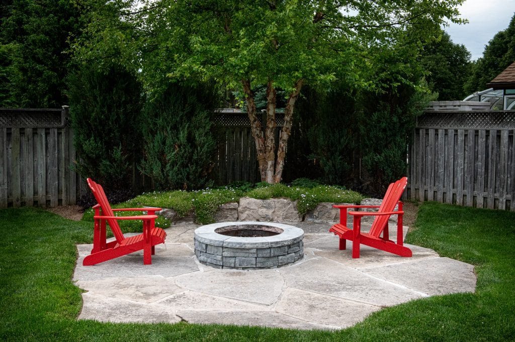 Residential backyard seating area with patio and landscape planting