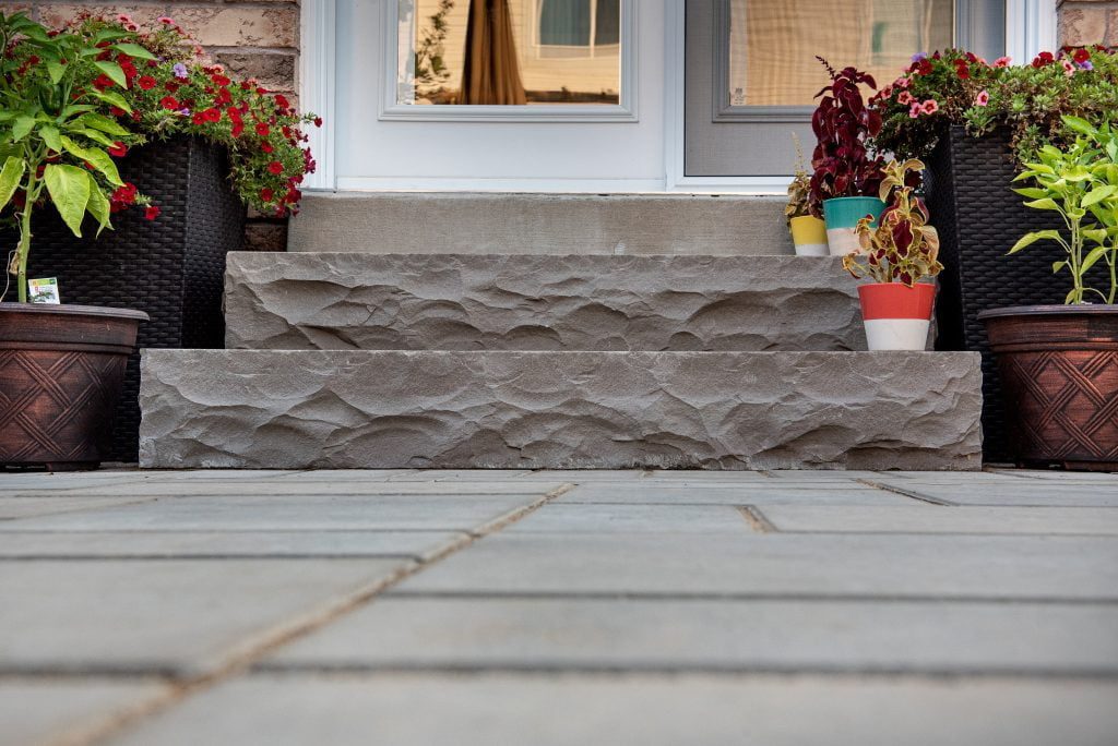 Stone backyard patio and steps in a Waterdown hardscaping project