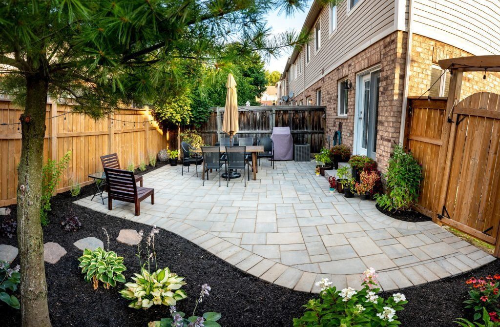 Stone backyard patio in Waterdown with room for outdoor entertaining