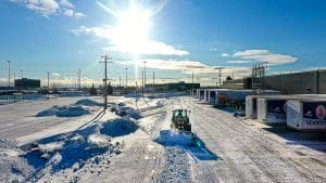 Creative Concepts Commercial snow removal services, skid steer clearing snow.