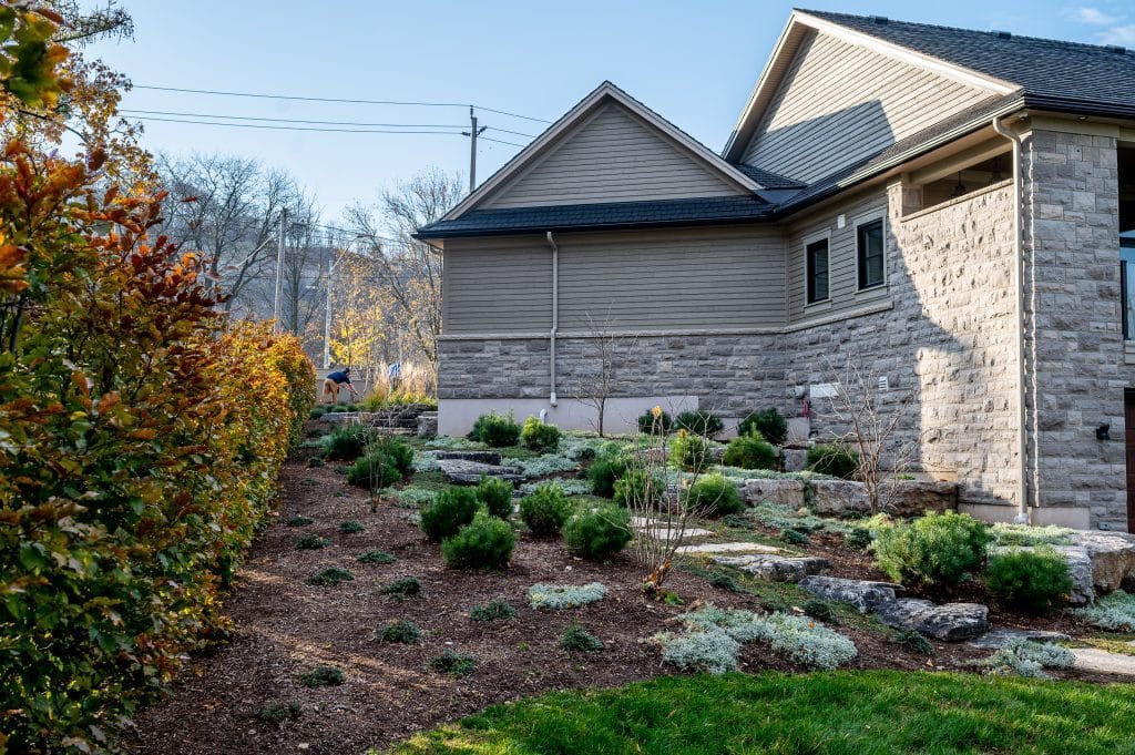 Natural stone walkway through backyard garden planting