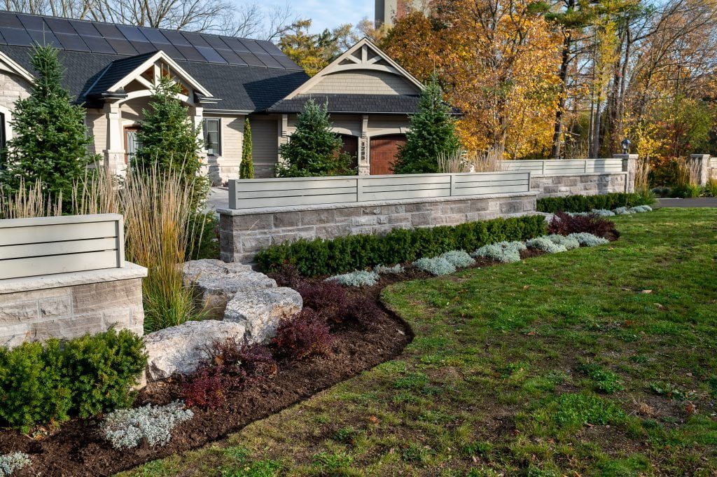 Front yard landscaping project with stone raised gardens.