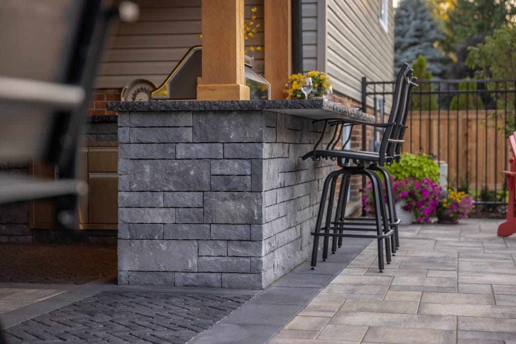 Backyard bar counter with poolside patio seating in Dundas Ontario