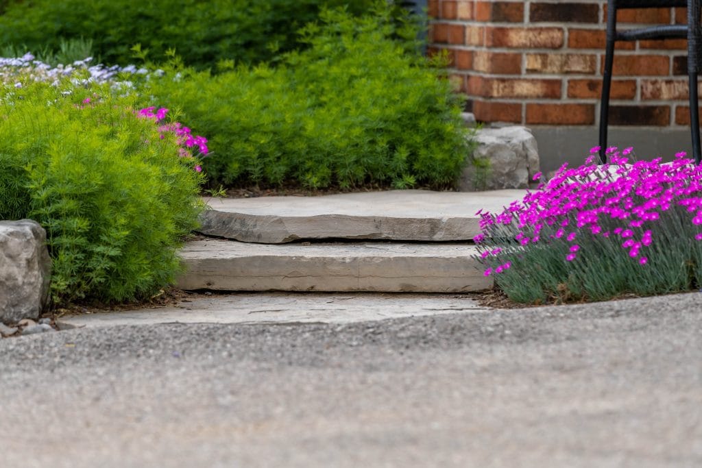 Natural stone path and garden hardscaping in an Ontario yard