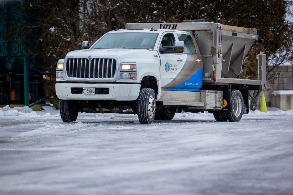 Creative Concepts Commercial snow removal services, truck spreading salt