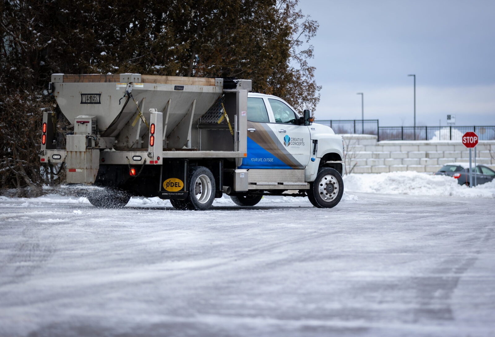 Creative Concepts Commercial snow removal services, truck spreading salt