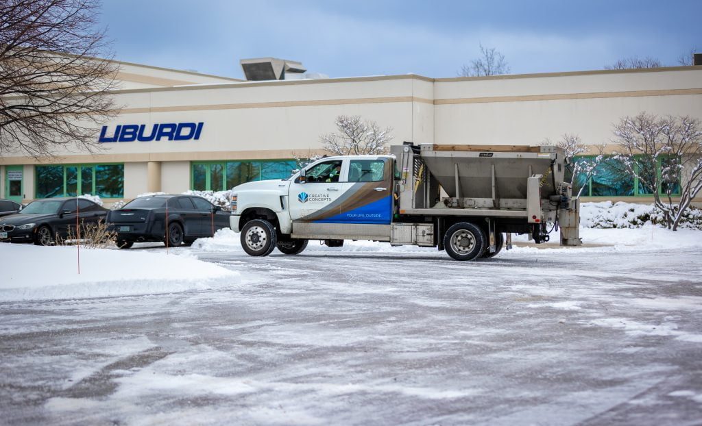 Creative Concepts Commercial snow removal services, truck spreading salt