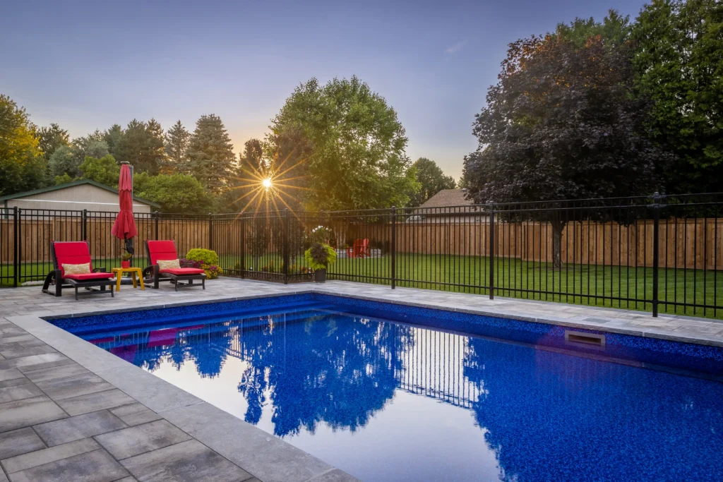 backyard pool with gate around it and beautiful landscaping. Project by Creative Concepts Landscaping in Dundas Ontario.