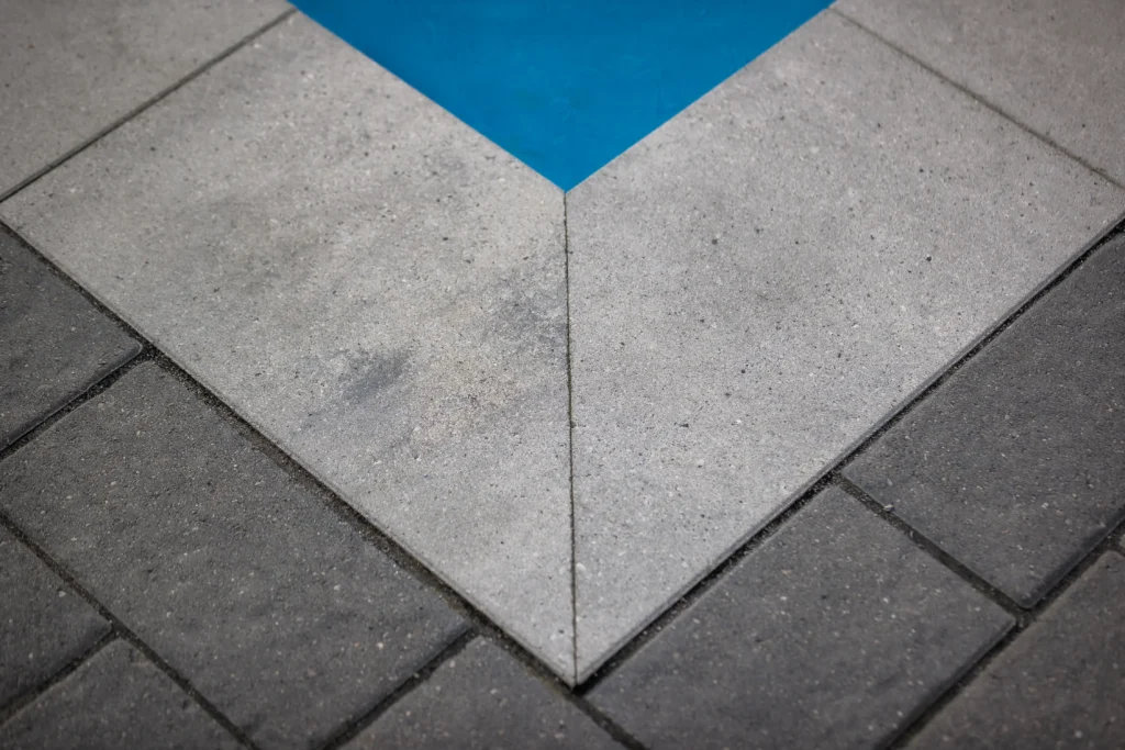 Burlington backyard stonework with patio and poolside planting