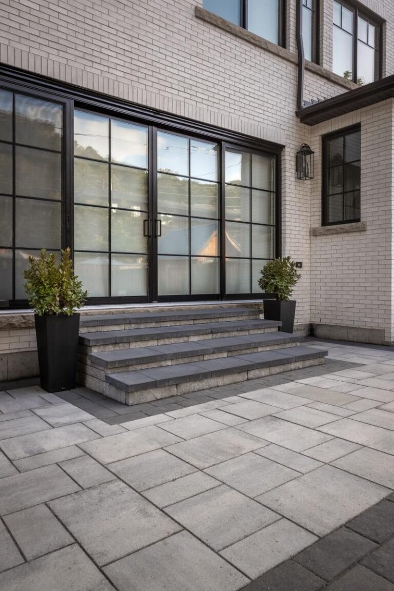 Small backyard landscaping ideas from Creative Concepts showing interlocking stone and natural stone steps from a patio.
