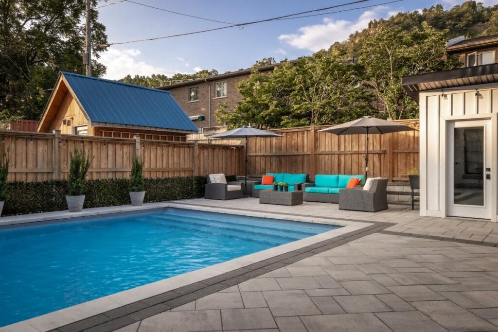 Backyard pool landscaping with patio, privacy, and garden planting