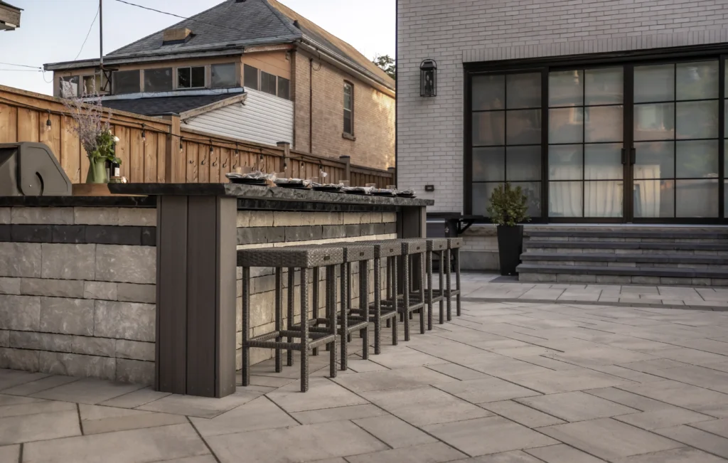 Outdoor bar and lounge area with backyard patio landscaping