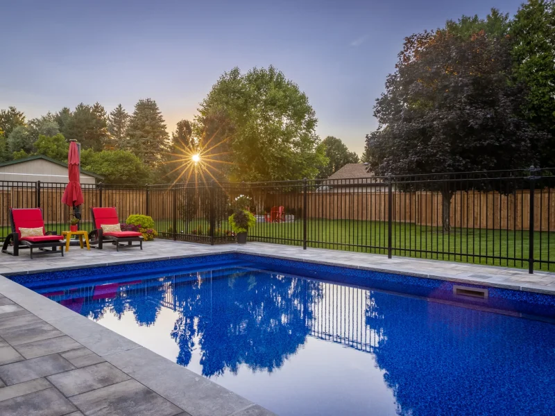 backyard pool with gate around it and beautiful landscaping. Project by Creative Concepts Landscaping in Dundas Ontario.
